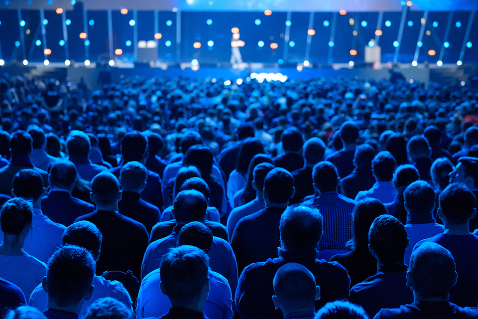 dark room of people at a conference